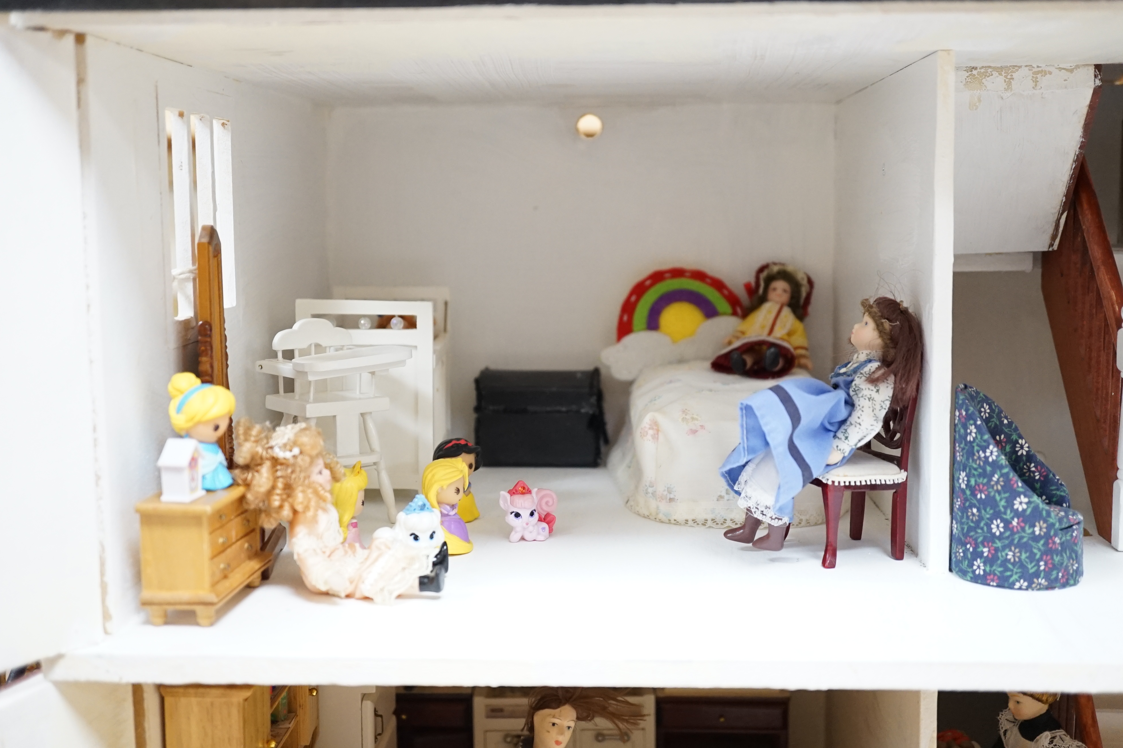 A painted doll's house with dolls and furniture, dolls house 78.5cm wide, 67cm high